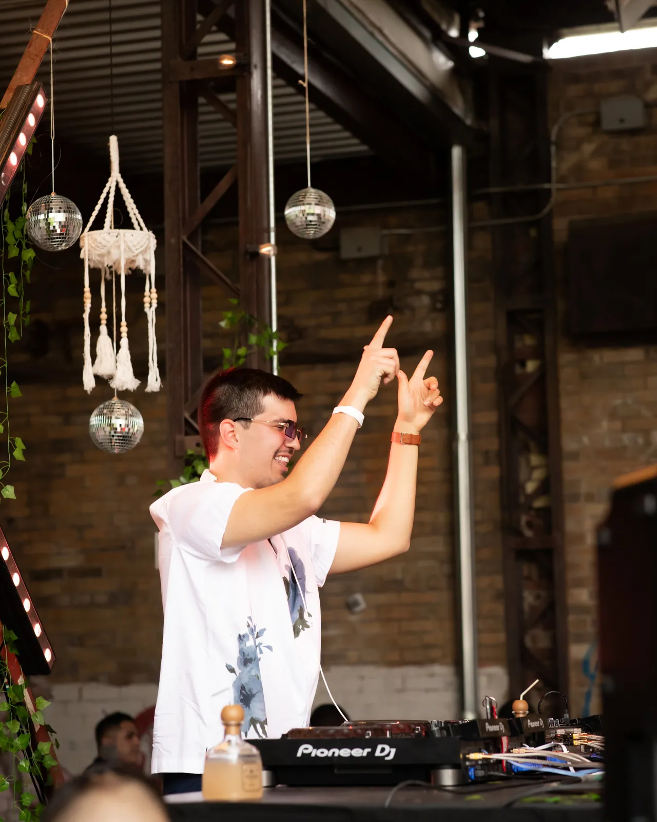 Azul with both hands up behind the decks at Por Que No, Toronto