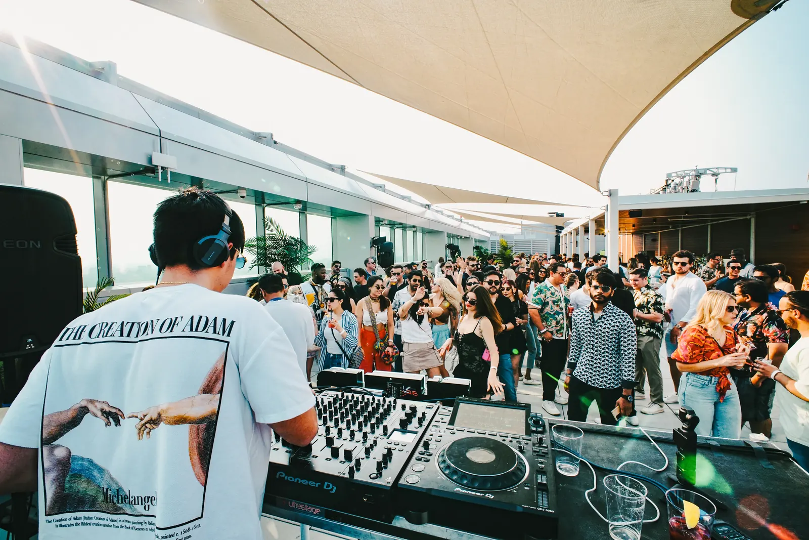 View from behind the decks over a rooftop crowd